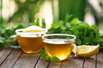 Cups of mint tea on wooden table lifestyle