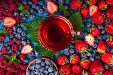 Herbal berry tea cup with blueberries and spices