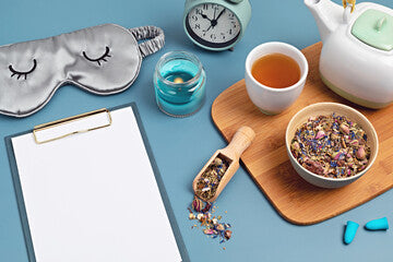 Classic alarm clock and herbal tea sleep concept flat lay