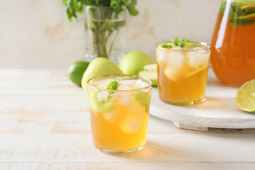Glasses of tasty iced tea on wooden background