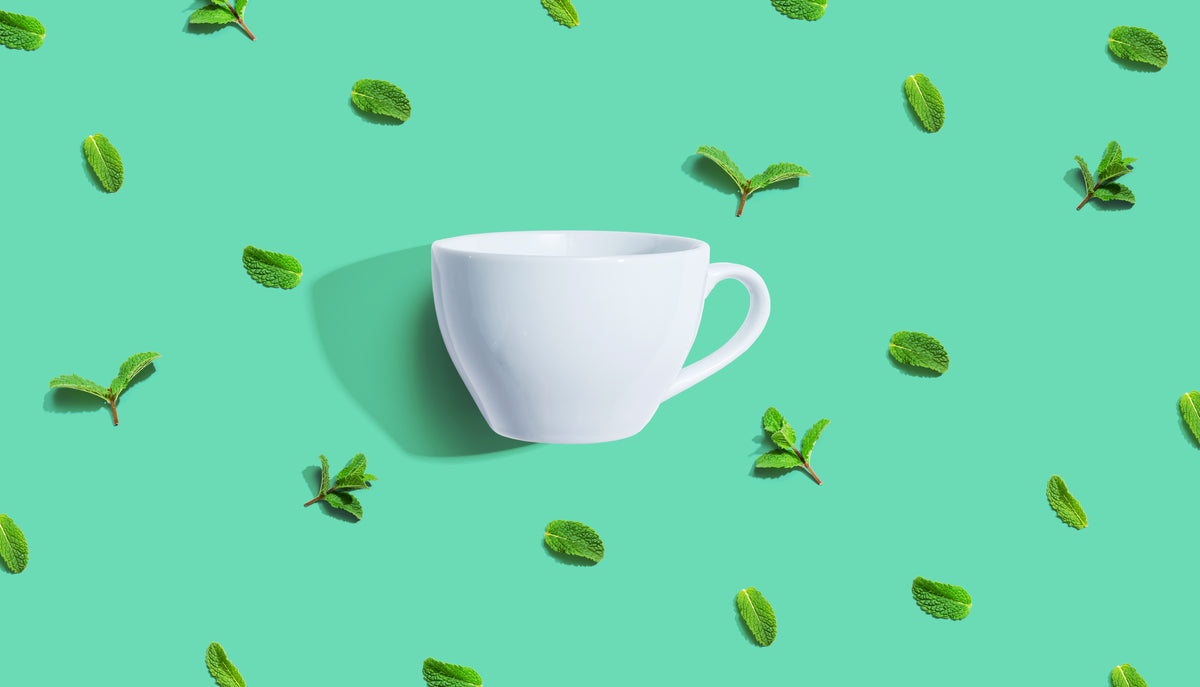 Fresh mint leaves with tea cup overhead view