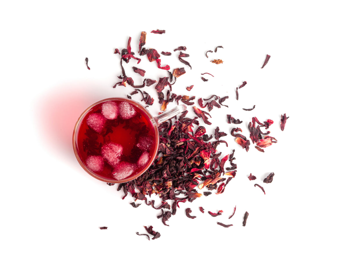 Hibiscus Lemon Lift hot tea in a transparent mug, ruby red color