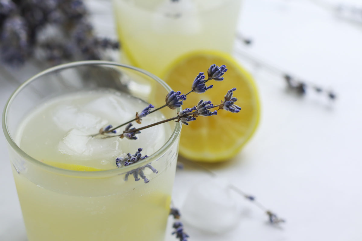 Tasty homemade lavender lemonade on light background