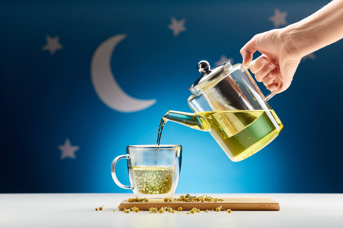 Hand pouring chamomile tea at night with stars and moon background